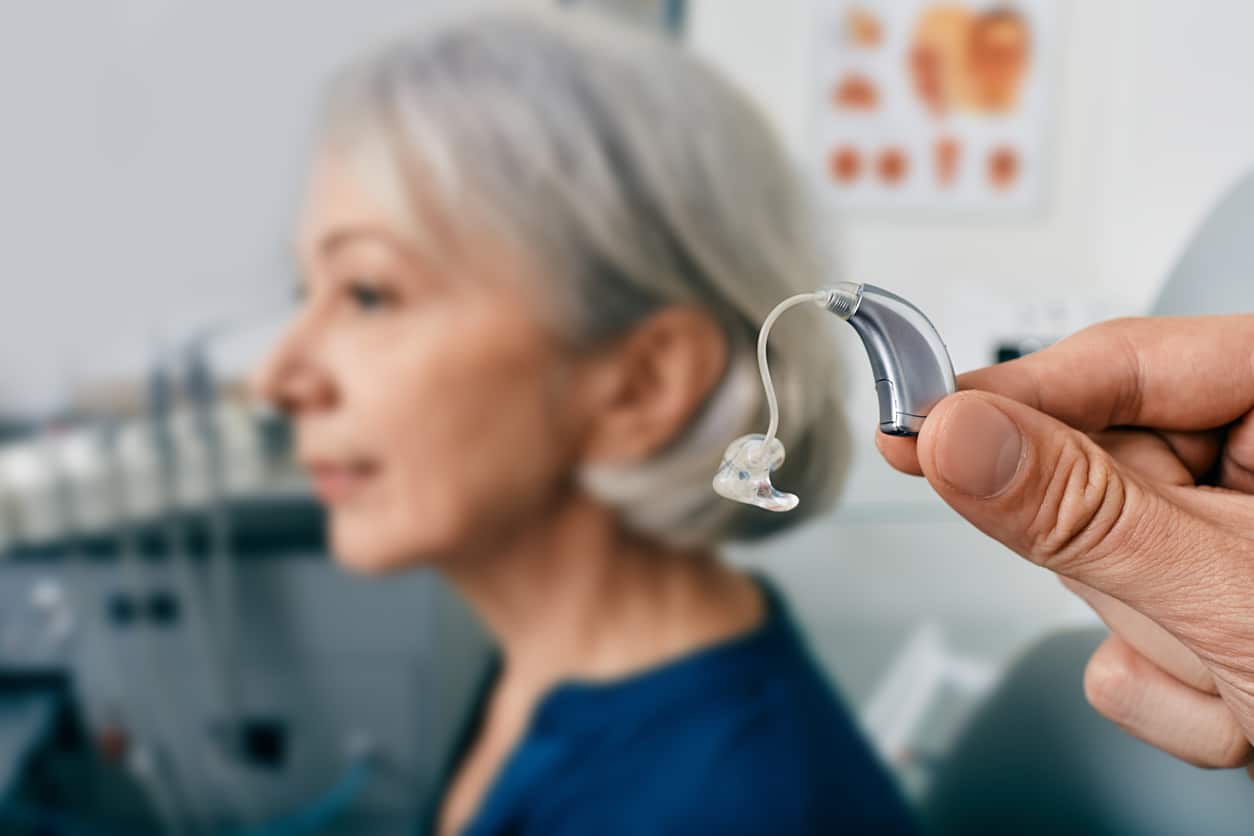 Woman getting a new hearing aid for her tinnitus.