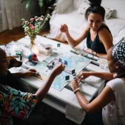 Three friends playing a board game